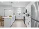 Well-lit kitchen featuring white cabinets, a breakfast bar, and modern appliances at 2352 Stuart St, Indianapolis, IN 46218