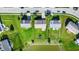 Aerial view featuring well-maintained yards, patios, and a community pond at 241 Green Meadow Dr, Indianapolis, IN 46229