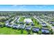 Serene aerial view of a residential neighborhood featuring lush greenery and a tranquil pond at 241 Green Meadow Dr, Indianapolis, IN 46229