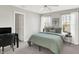 Well-lit bedroom with a desk and neutral colors at 241 Green Meadow Dr, Indianapolis, IN 46229