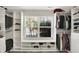 Well-organized walk-in closet with window bench, custom shelving and shoe storage at 241 Green Meadow Dr, Indianapolis, IN 46229