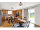 Bright dining area boasts a round table, chandelier and access to the kitchen and backyard at 241 Green Meadow Dr, Indianapolis, IN 46229