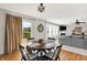 Open dining area showcases a round table, backyard access and adjoins the living room at 241 Green Meadow Dr, Indianapolis, IN 46229