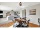 Open dining area showcases a round table, chandelier and adjoins the living room at 241 Green Meadow Dr, Indianapolis, IN 46229