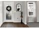 Bright entryway featuring a decorative front door, stylish mirror, and neutral decor at 241 Green Meadow Dr, Indianapolis, IN 46229