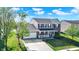 Charming two-story home with a well-manicured lawn, an attached two-car garage, and inviting front porch at 241 Green Meadow Dr, Indianapolis, IN 46229
