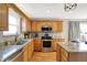 Open concept kitchen with stainless appliances, granite counters, and wooden cabinets at 241 Green Meadow Dr, Indianapolis, IN 46229