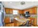 Bright kitchen features wooden cabinets, granite countertops and stainless steel appliances at 241 Green Meadow Dr, Indianapolis, IN 46229