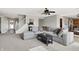 Inviting living room features a large sectional sofa, fireplace, and adjoining staircase and dining area at 241 Green Meadow Dr, Indianapolis, IN 46229