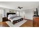 Comfortable primary bedroom with hardwood floors, a ceiling fan, and stylish decor at 241 Green Meadow Dr, Indianapolis, IN 46229