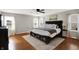Spacious primary bedroom with hardwood floors, a ceiling fan, and ample natural light at 241 Green Meadow Dr, Indianapolis, IN 46229