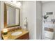 Cozy powder room featuring a granite countertop, decorative mirror, and charming accents at 241 Green Meadow Dr, Indianapolis, IN 46229