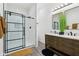 Stylish bathroom featuring a modern vanity, walk-in shower with glass door and black trim at 2428 N Gale St, Indianapolis, IN 46218