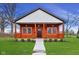 Charming home with a inviting front porch, updated landscaping, and a lovely walkway at 2428 N Gale St, Indianapolis, IN 46218