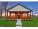 Charming home featuring a cozy front porch and well-manicured lawn, offering a welcoming and inviting exterior appeal at 2428 N Gale St, Indianapolis, IN 46218