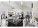Bright open-concept living room flows to dining area, featuring a fireplace, modern fixtures, and sleek flooring at 2428 N Gale St, Indianapolis, IN 46218