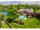 Expansive backyard with pool, tennis court, and lush landscaping surrounds this elegant brick home at 290 Breakwater Dr, Fishers, IN 46037