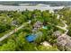 Aerial view of a luxury home on a large lot with a pool and tennis court near a lake at 290 Breakwater Dr, Fishers, IN 46037