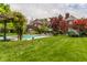 Expansive backyard featuring a pool, patio furniture, and mature landscaping at 290 Breakwater Dr, Fishers, IN 46037