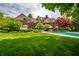 Beautiful backyard with a swimming pool, a lush lawn and mature trees at 290 Breakwater Dr, Fishers, IN 46037