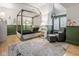 Stylishly decorated bedroom with a gray canopy bed, green wainscoting, and ample natural light at 290 Breakwater Dr, Fishers, IN 46037