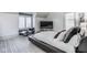 Modern bedroom with a sleek platform bed, lounge chair, plush carpet, and bright window at 290 Breakwater Dr, Fishers, IN 46037