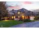 Elegant home with manicured lawn, mature trees, and a well-lit exterior offers timeless appeal at 290 Breakwater Dr, Fishers, IN 46037