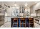 Bright kitchen featuring marble floors, an island with seating, and stainless steel appliances at 290 Breakwater Dr, Fishers, IN 46037