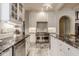 Gourmet kitchen featuring stainless appliances, white cabinetry, tile floors and stunning countertops at 290 Breakwater Dr, Fishers, IN 46037