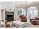 Bright living room with fireplace, stylish seating, and grand piano at 290 Breakwater Dr, Fishers, IN 46037