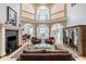 Elegant two-story living room with fireplace, hardwood floors, and ample natural light at 290 Breakwater Dr, Fishers, IN 46037