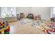 Spacious playroom with multiple rugs, a toddler bed, and furniture at 290 Breakwater Dr, Fishers, IN 46037