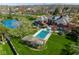 Aerial image of a brick home with a pool and covered patio in a well-manicured yard at 290 Breakwater Dr, Fishers, IN 46037