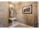 Charming powder room featuring patterned wallpaper, a pedestal sink, and elegant lighting at 290 Breakwater Dr, Fishers, IN 46037