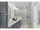 Stylish bathroom with double vanity, a glass-enclosed shower with marble tile, and modern fixtures at 315 E Minnesota St, Indianapolis, IN 46225