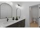 Elegant bathroom showcasing a double vanity with dark wood cabinets and modern fixtures near the toilet at 315 E Minnesota St, Indianapolis, IN 46225