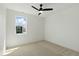 Bedroom with plush carpeting, a ceiling fan, a bright window, and white walls at 315 E Minnesota St, Indianapolis, IN 46225