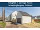 A roughed-in carriage house stands ready for customization with a gray garage door and white siding at 315 E Minnesota St, Indianapolis, IN 46225