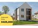 New construction modern home with a balcony, neutral siding, manicured landscaping, and a grassy front lawn at 315 E Minnesota St, Indianapolis, IN 46225