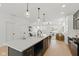 Bright and airy kitchen featuring a large island, stainless steel appliances, and seamless flow to the living space at 315 E Minnesota St, Indianapolis, IN 46225