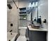 Stylish bathroom with a modern black vessel sink, sleek mirror, and a tiled shower, offering a luxurious experience at 334 N Chester Ave, Indianapolis, IN 46201