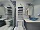 Stylish bathroom featuring a unique vessel sink, modern fixtures, and sleek black and white marble-patterned shower at 334 N Chester Ave, Indianapolis, IN 46201