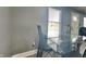 Contemporary dining area with a glass-top table, stylish chairs, and ample natural light at 334 N Chester Ave, Indianapolis, IN 46201