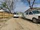 Exterior shot of the home featuring two white vehicles parked in the front driveway at 334 N Chester Ave, Indianapolis, IN 46201