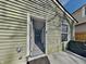 Exterior angle shot featuring light green siding, white trim, a doorway, and the interior hallway at 334 N Chester Ave, Indianapolis, IN 46201