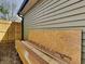 Exterior side view of home with wood fence, siding, and construction materials at 334 N Chester Ave, Indianapolis, IN 46201