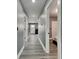 A long hallway with gray walls and hardwood floors leads to various rooms in the home at 334 N Chester Ave, Indianapolis, IN 46201