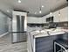 Bright kitchen featuring stainless steel appliances, quartz counters, updated cabinetry, and modern lighting at 334 N Chester Ave, Indianapolis, IN 46201