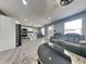 An open-concept living room with modern furniture, gray walls, and gray flooring at 334 N Chester Ave, Indianapolis, IN 46201