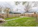 Fenced backyard featuring a well-maintained lawn and a quaint walkway leading to the back gate at 341 Sanders St, Indianapolis, IN 46225